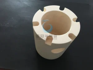 Top-down view of a ceramic cylinder showing internal features and notched rim.