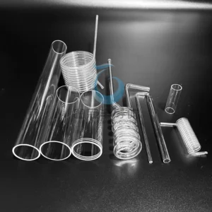 Assortment of clear Fused Quartz tubes, including long straight tubes and various coiled heat exchanger coils.
