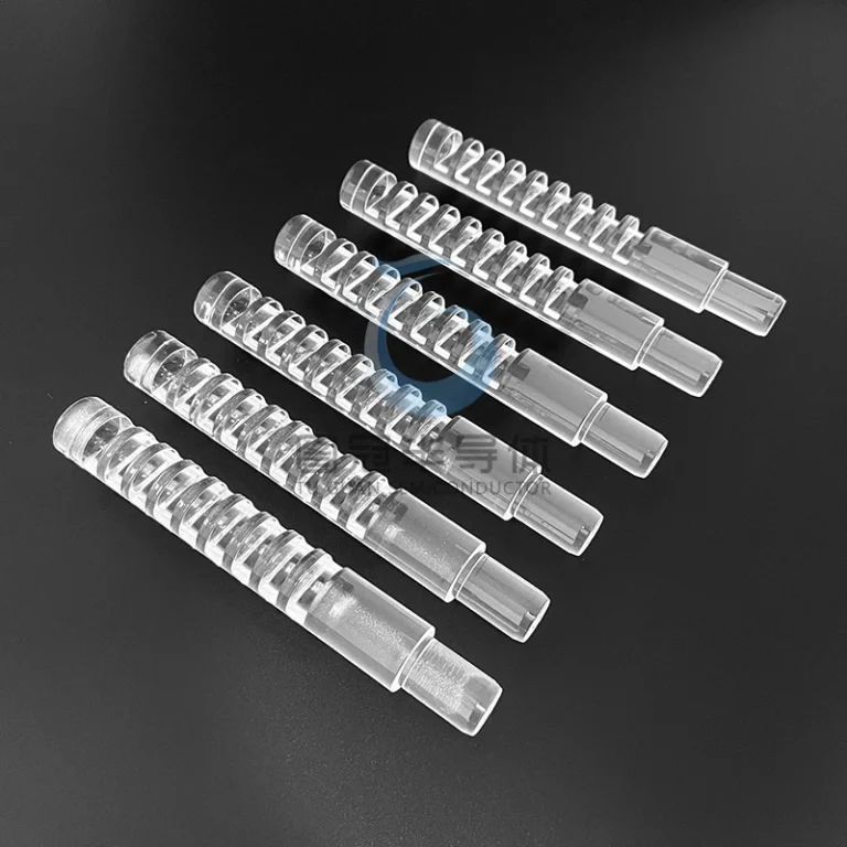 Multiple clear Fused Quartz cylindrical shafts with precise spiral grooves, designed for wafer stacking.