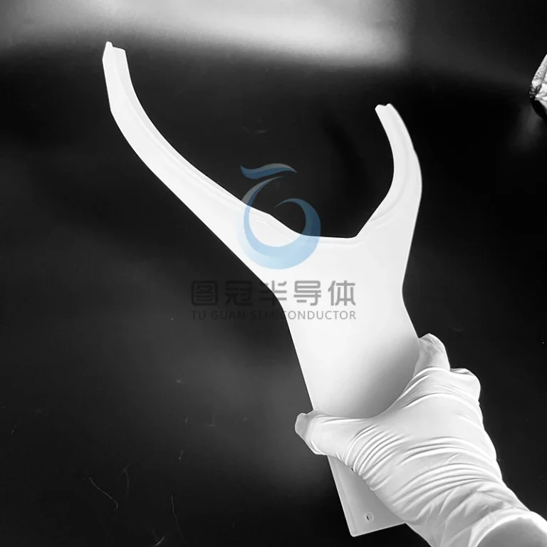 White gloved hand holding a custom-shaped frosted Fused Quartz mechanical gripper.