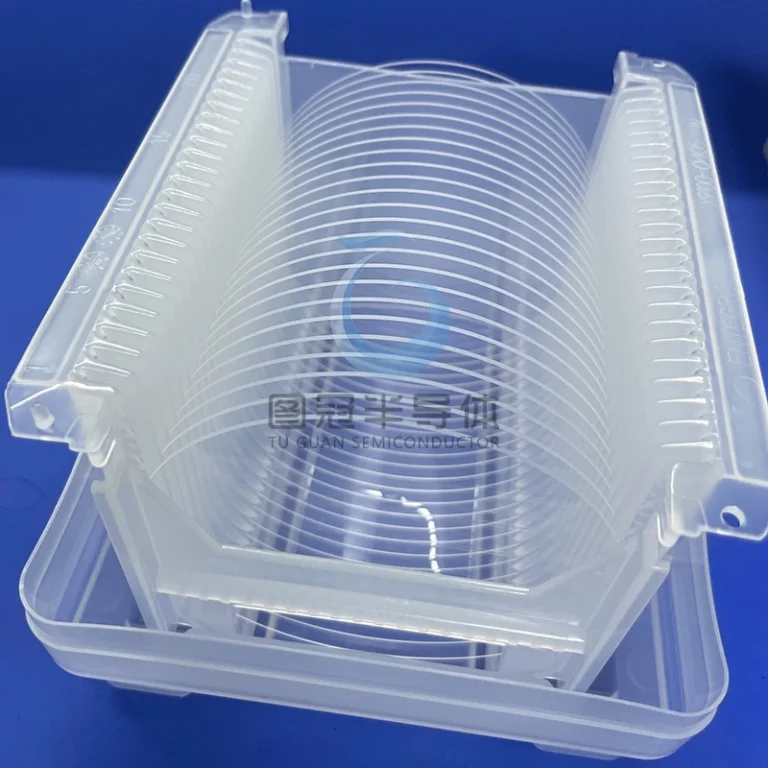 Multiple clear Fused Quartz wafers stacked neatly inside a translucent plastic wafer cassette
