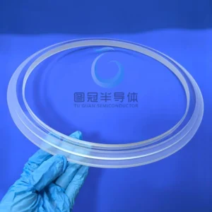 a large, clear, circular Fused Quartz viewing window with intricate etched concentric and radial patterns.