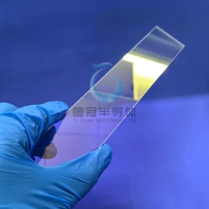 a clear, rectangular Fused Quartz window demonstrating high infrared transmission with a yellow reflection