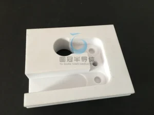 Large custom ceramic base plate with precision cutouts for vacuum chambers.