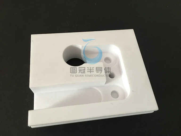 Large custom ceramic base plate with precision cutouts for vacuum chambers.