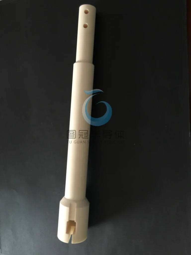 Long, custom-machined ceramic rod with holes and a specialized base.