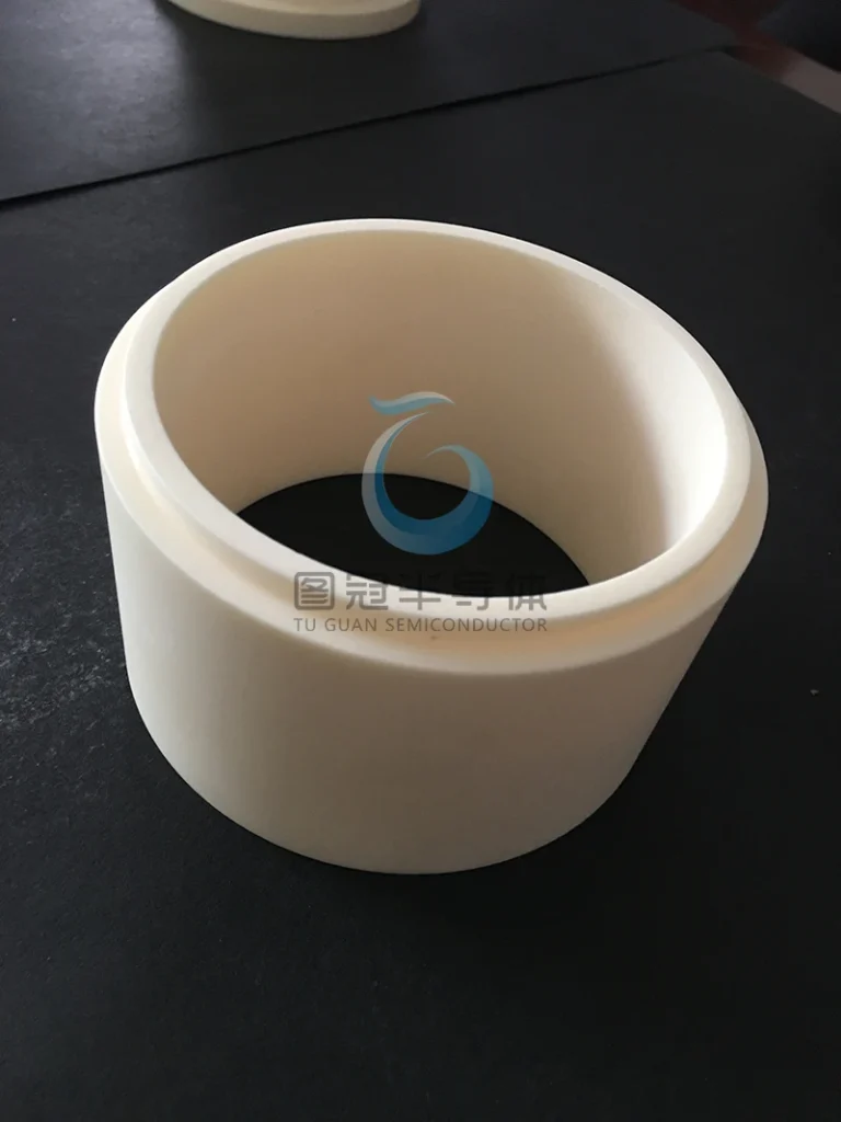 Ceramic cylinder with a stepped outer profile and smooth inner wall.