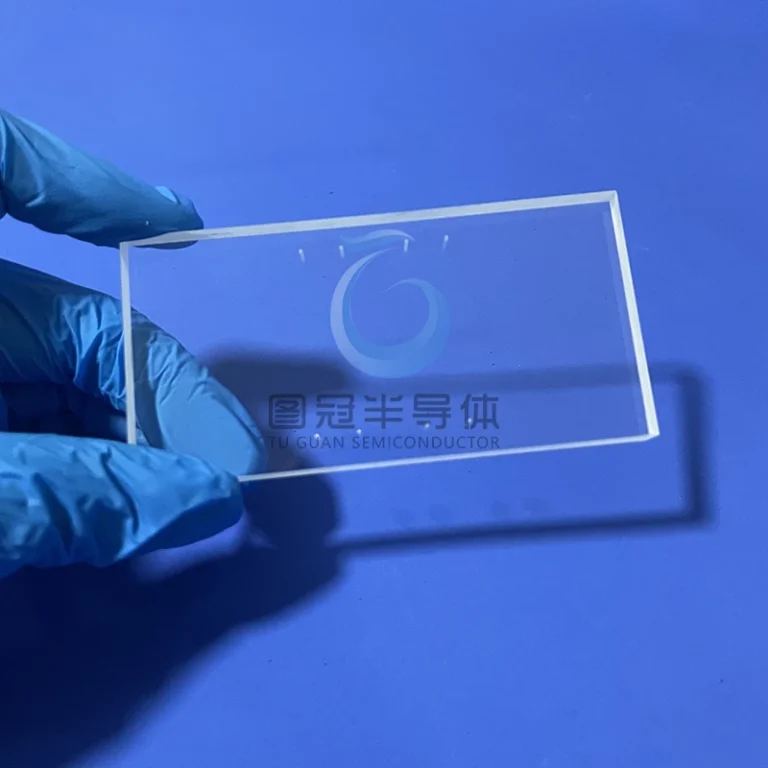 a clear, rectangular Fused Quartz window with small circular indentations or holes on its surface