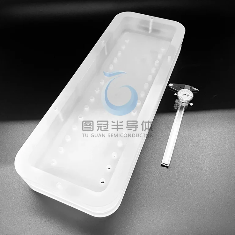 Long, clear fused silica tray with multiple precision-drilled holes, next to a caliper