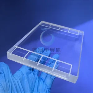 Clear Fused Quartz rectangular plate with deep, intricate internal channels and a rounded opening