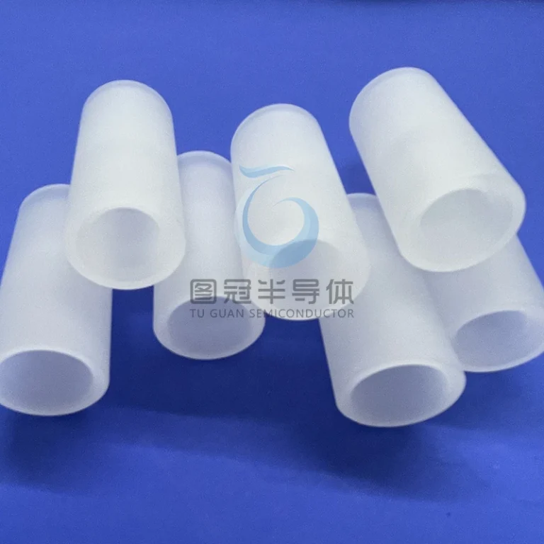 Group of frosted or translucent sapphire glass tubes of varying lengths and diameters, arranged on a blue surface.